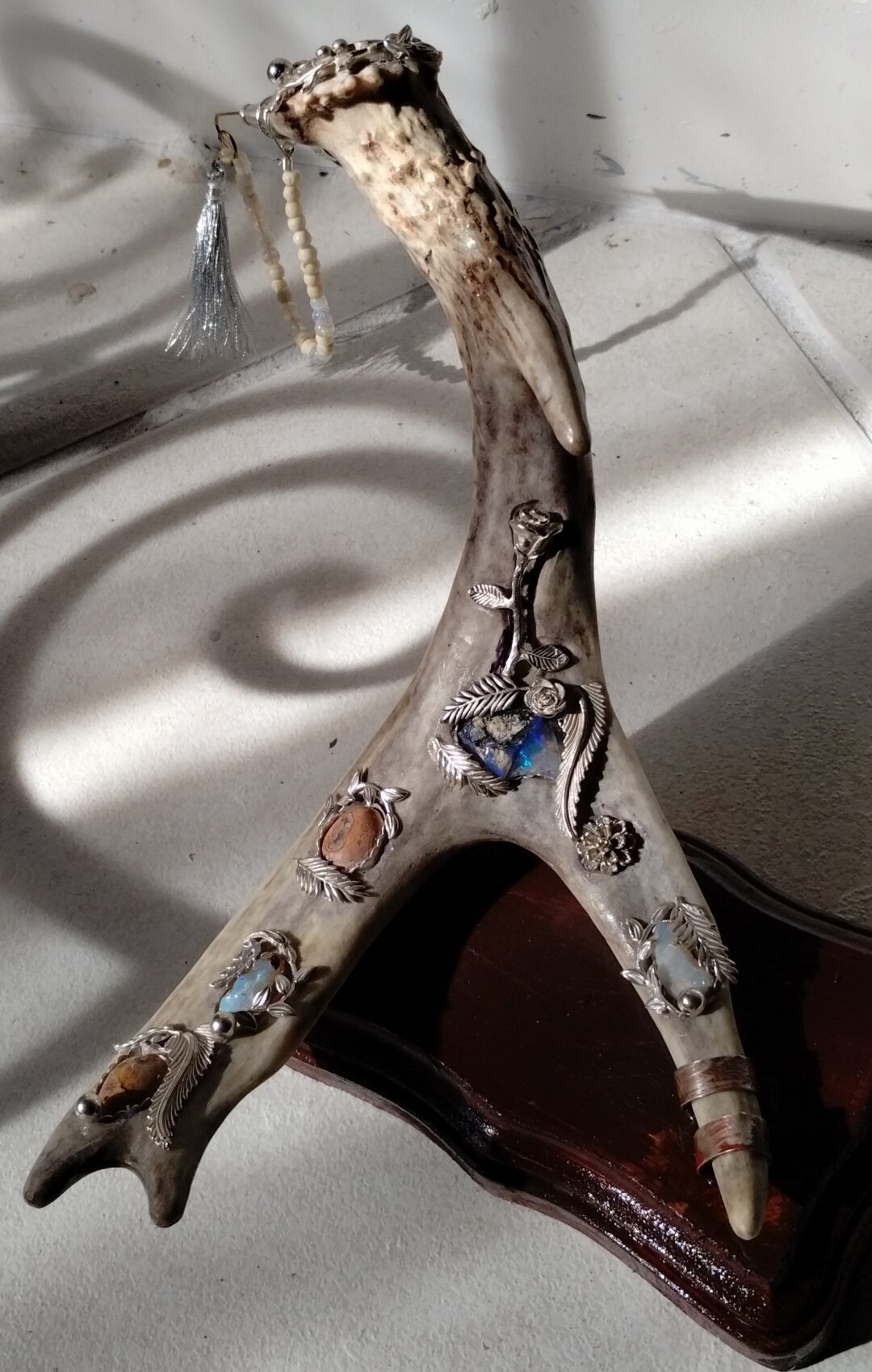 Close-up of a ceramic antler with painted animal designs.