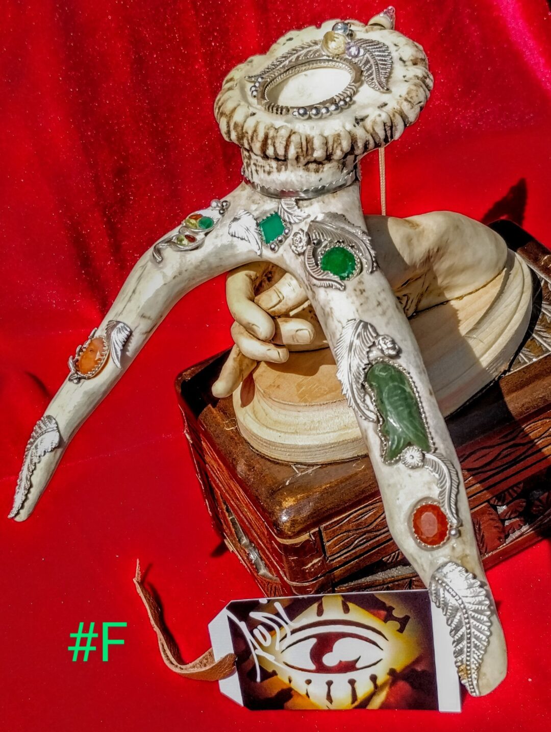 Hand-painted mannequin arms with detailed designs on a wooden box.