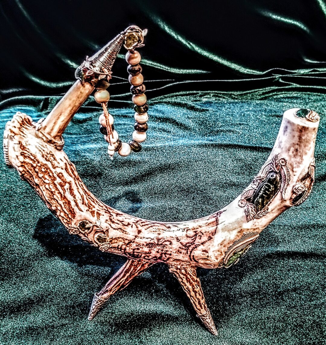 Intricately carved wooden sculpture resembling an animal with spiked legs.