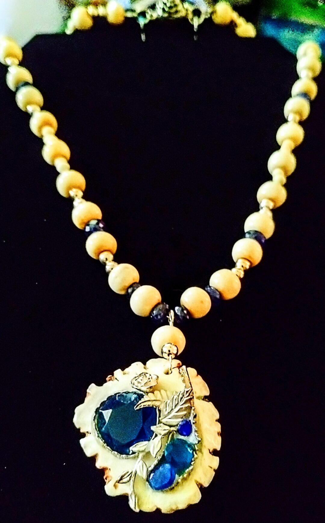 Elegant beaded necklace with a detailed pendant.