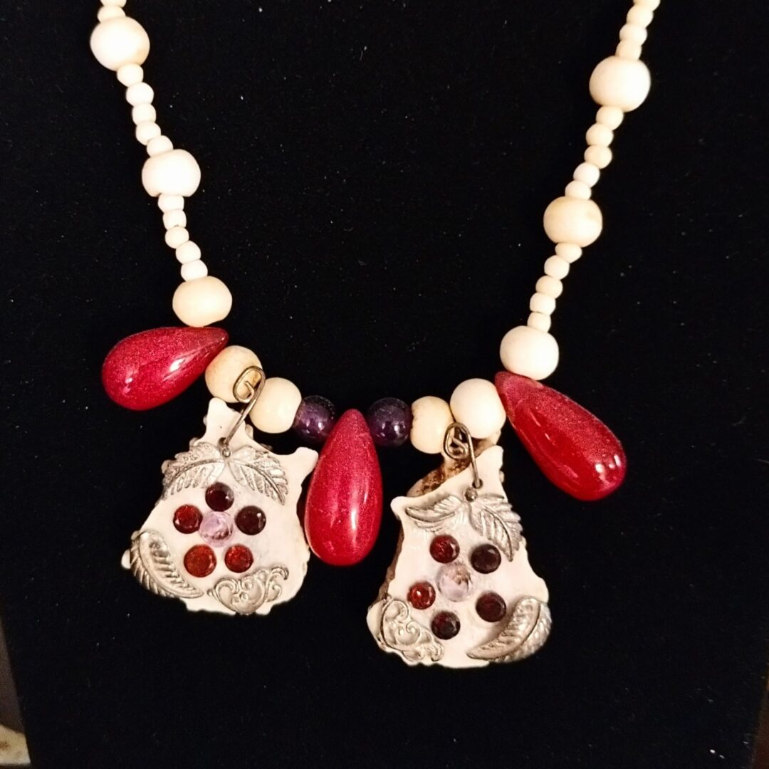 Beaded necklace with red and white accents.