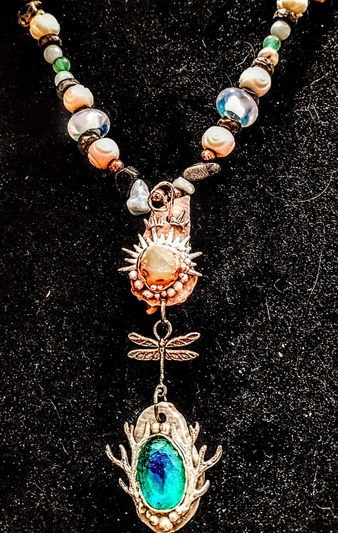 Colorful necklace featuring a blue gemstone